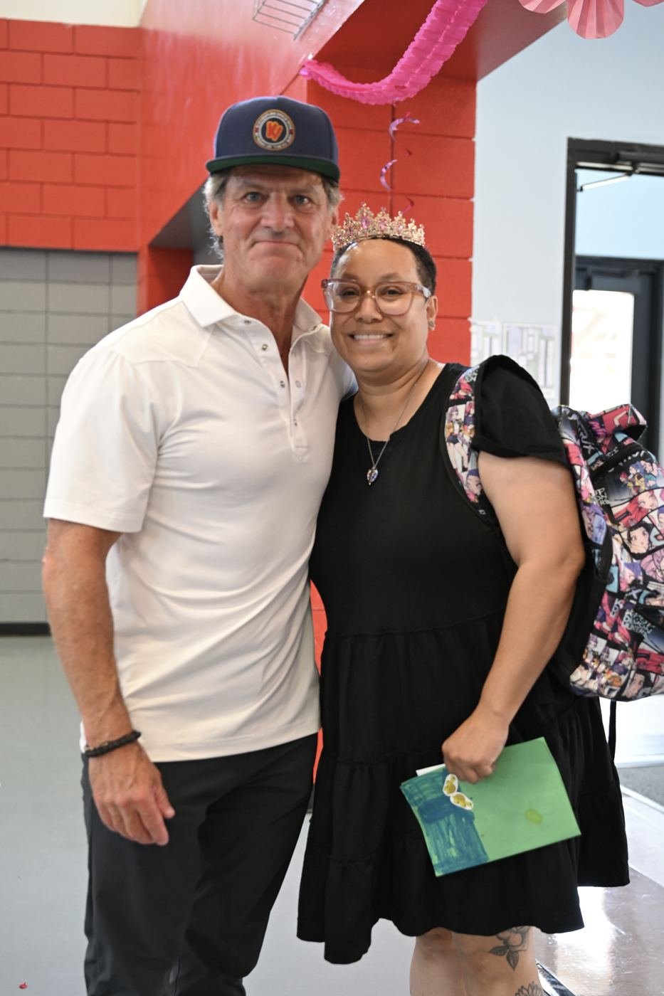 Two supporters smile together at the benefit