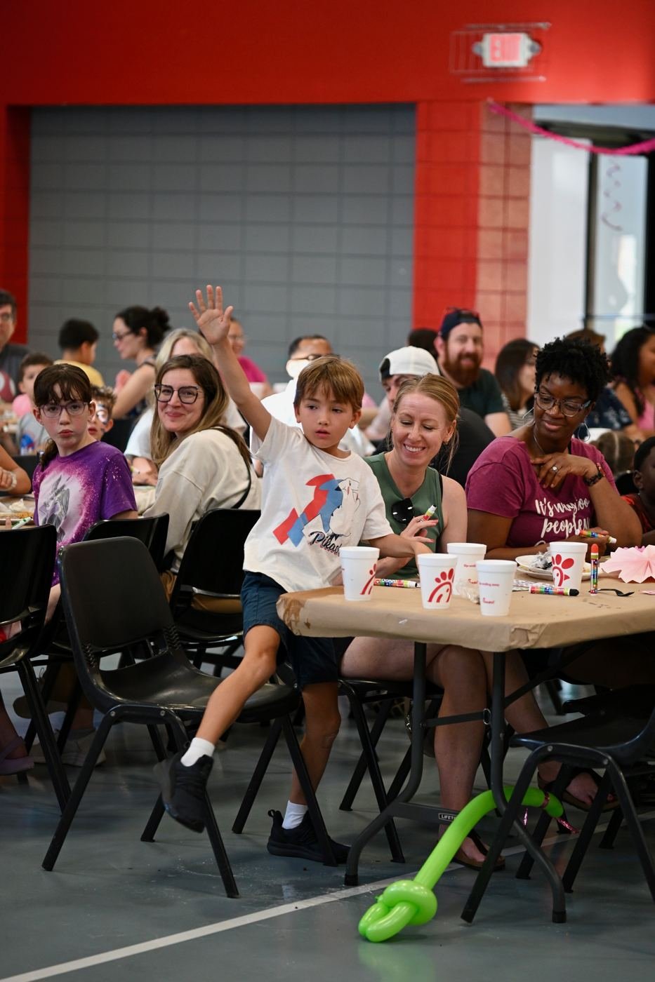 Guests raise their hands during a bingo round