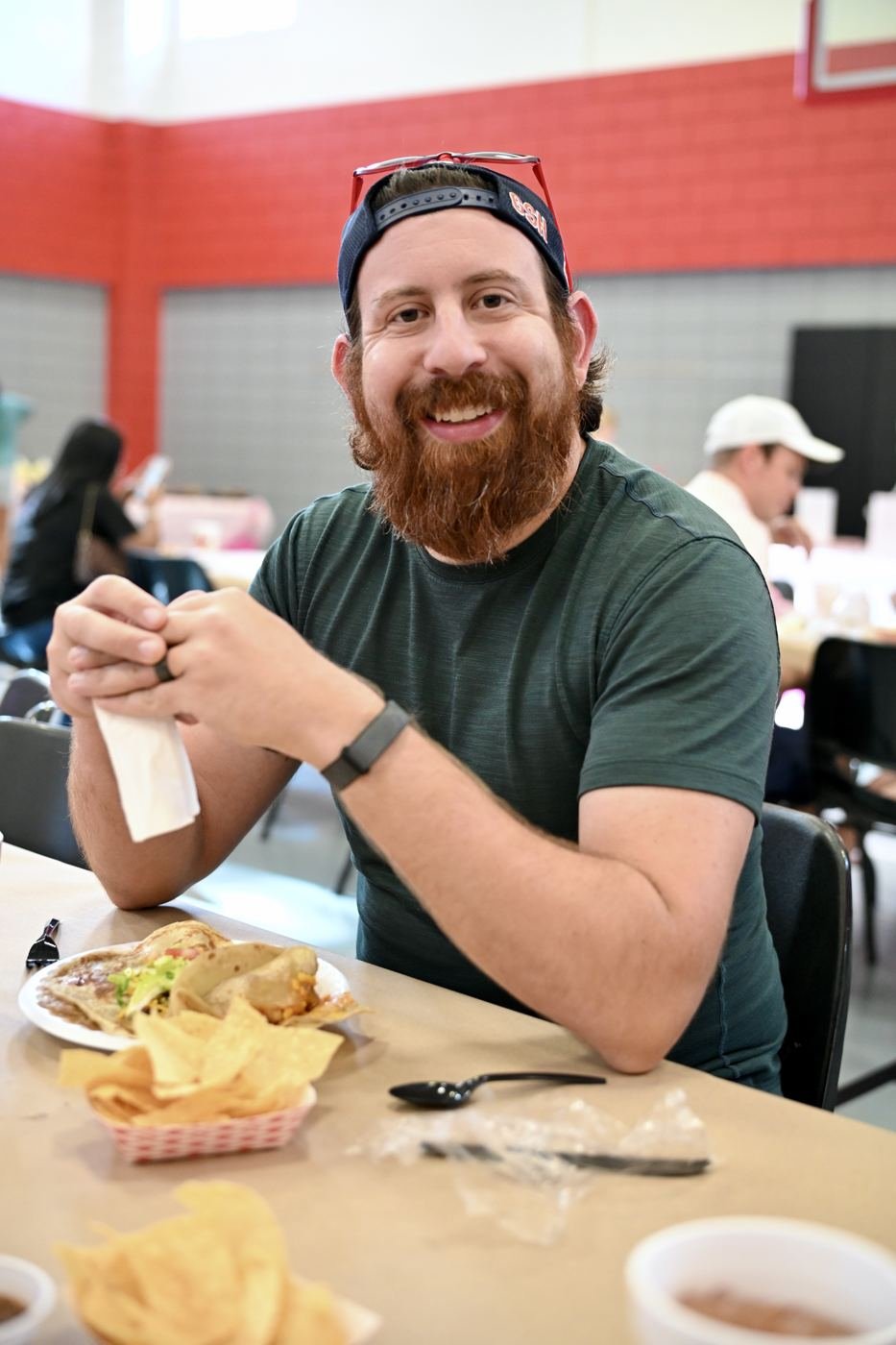 A guest smiles over dinner at the benefit
