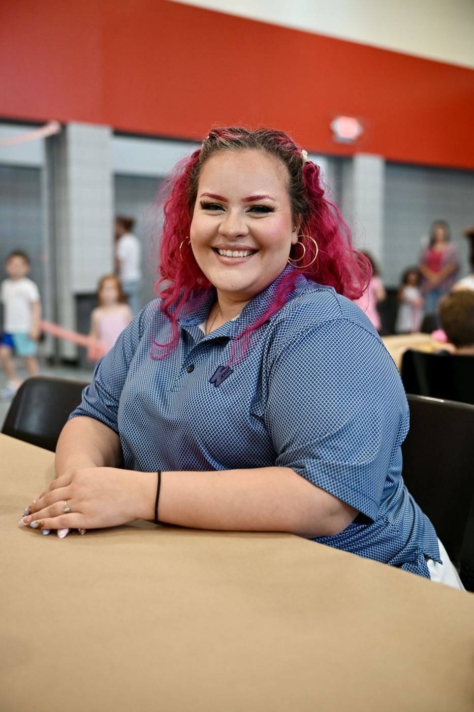 A volunteer smiles at the camera during the event