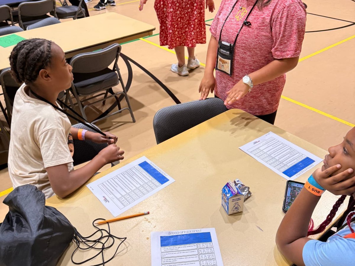 A camp director speaking with campers during a group check-in