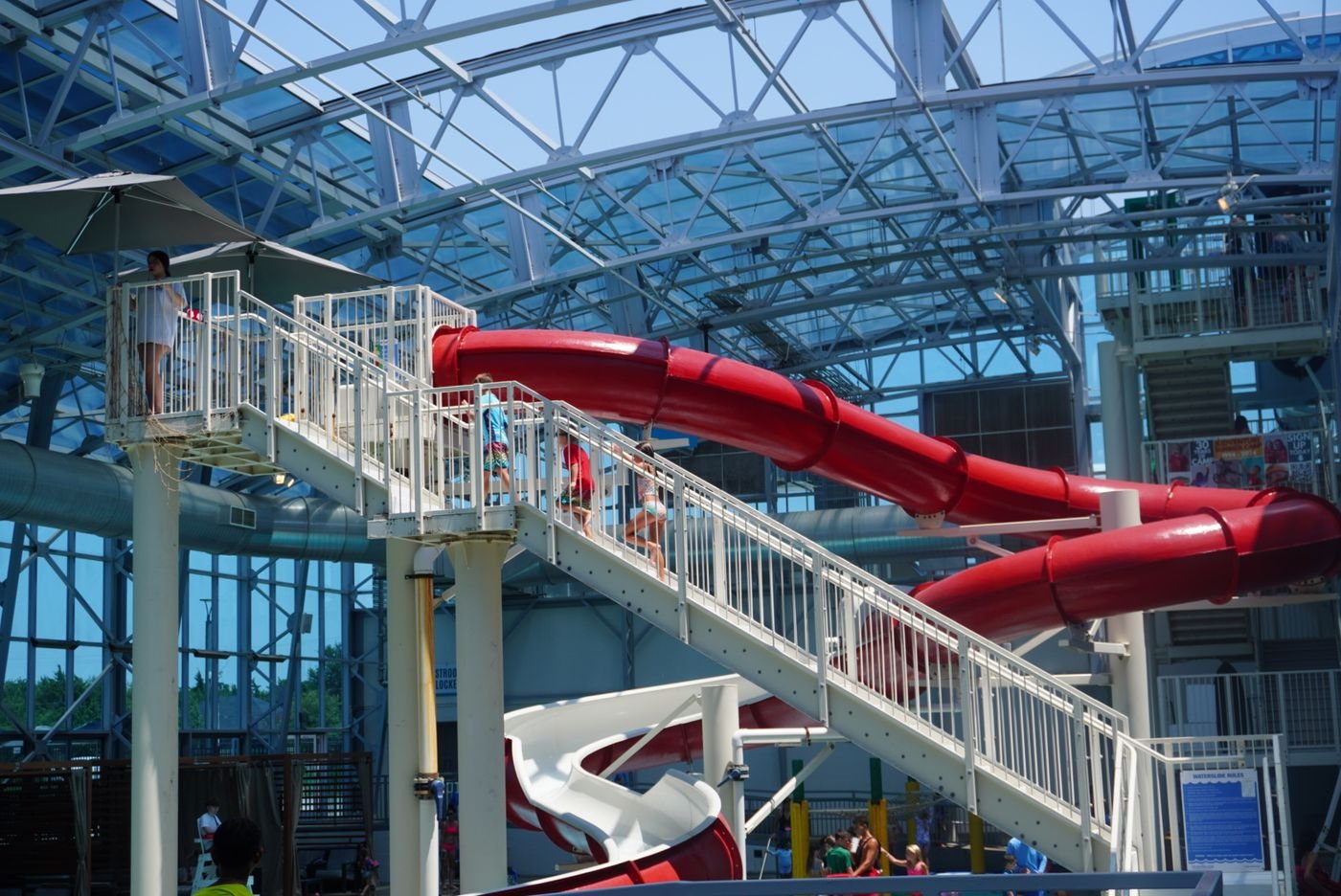 Campers climbing the stairs to a large water slide