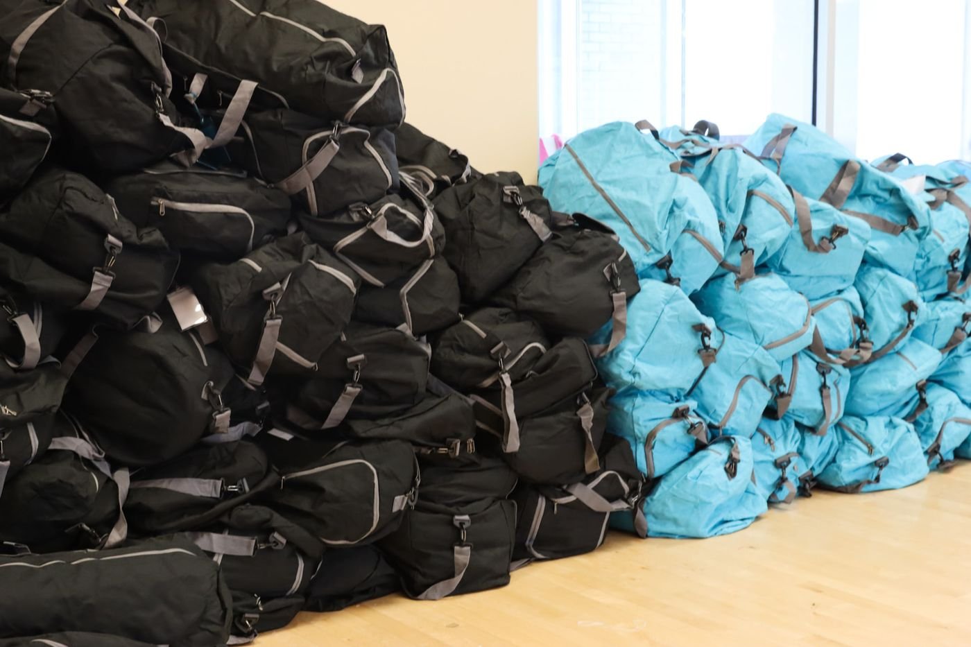 Stacks of packed duffel bags ready to be given to campers