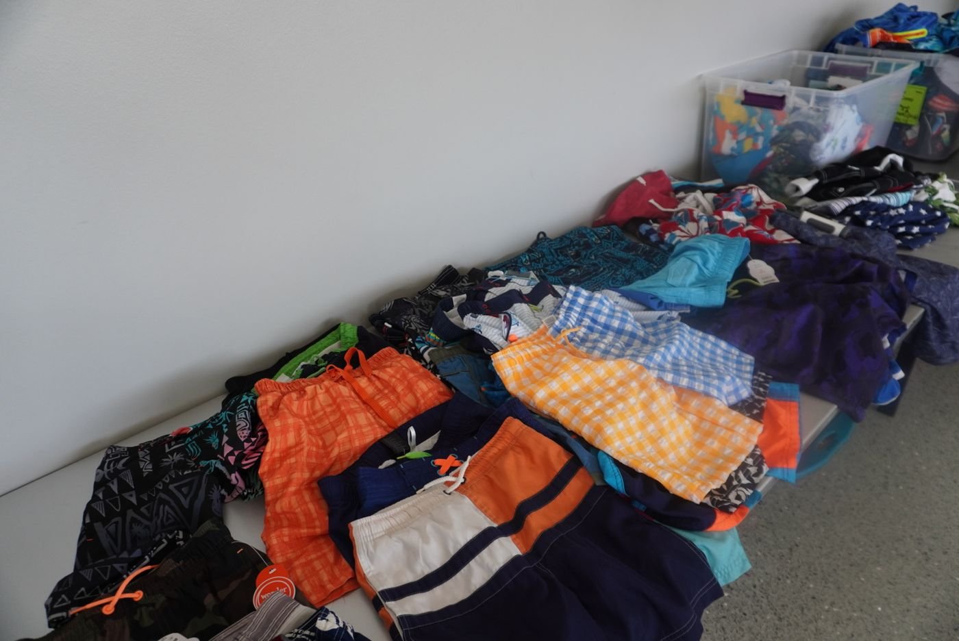 New swimsuits and clothing laid out and sorted for campers