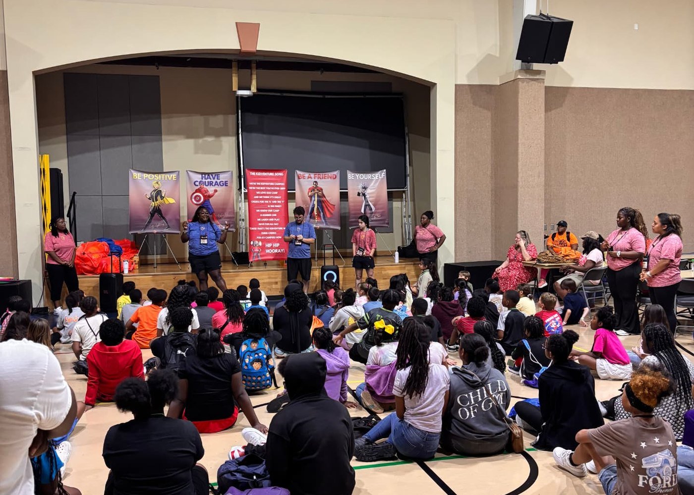 Campers gathered on a gym floor for an all-camp assembly