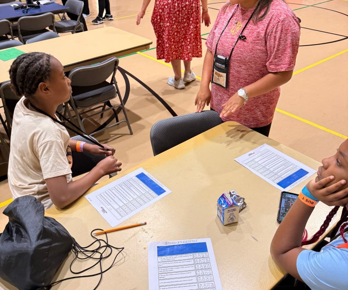 A camp director talking with campers during a group check-in